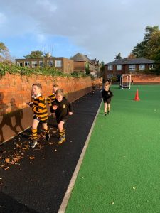 Children playing outside on the sports field at Inchmarlo.