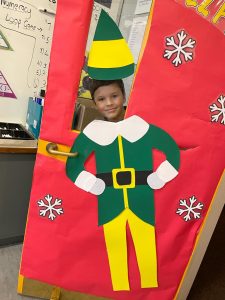 Child dressed as a festive elf at Inchmarlo school event.