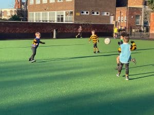 Children playing football at Inchmarlo sports field, outdoor activity, kids sports, healthy outdoor fun.