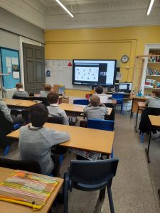 Students in a classroom using digital educational tools at Inchmarlo School.