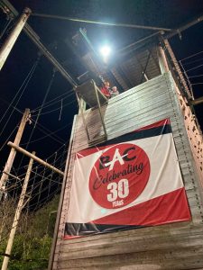 Night view of outdoor event at Inchmarlo estate with celebratory banner.