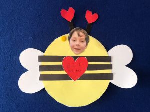Cheerful bee-themed love card with a child's face, perfect for special occasions.