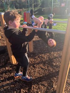 Child playing on outdoor equipment at Inchmarlo, a family-friendly location in Scotland.