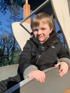 Child enjoying playground at Inchmarlo, outdoor family fun in a scenic estate setting.
