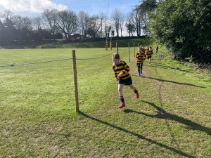 Children running on green field during outdoor activity at Inchmarlo.