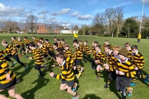 Children playing rugby in Inchmarlo grounds during outdoor sports activity.