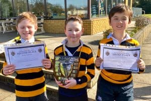 Three children holding awards at Inchmarlo Golf Club in Aberdeen.