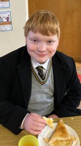 Young student enjoying a school meal at Inchmarlo.