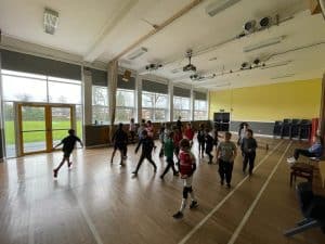 Bright indoor gym with children engaging in play activities at Inchmarlo.