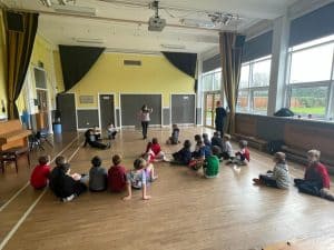 Bright classroom with children sitting on the floor, engaging in activities at Inchmarlo.