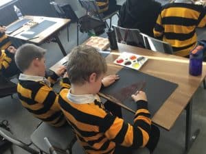 Children painting at Inchmarlo school craft session, engaging in creative activities.