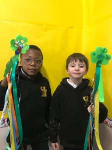 Two children celebrating with St. Patrick's Day decorations at Inchmarlo School.