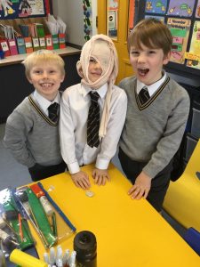 Happy children in school uniform at Inchmarlo Academy classroom.