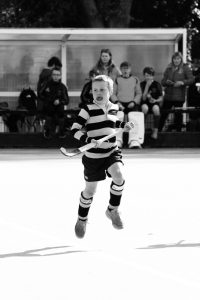 Young girl playing tennis outdoors at Inchmarlo Sports Club.