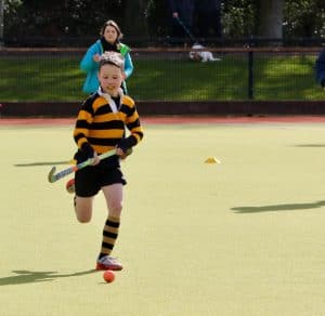 Young girl playing tennis at Inchmarlo sports facility.