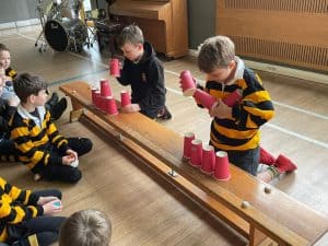 Children playing stacking cups at Inchmarlo, a family-friendly accommodation in Scotland.