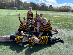 Kids playing rugby at Inchmarlo sports field, outdoor youth sports and team activities.