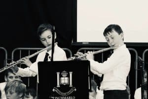Students performing with flutes during school event at Inchmarlo.