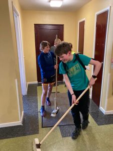 Children cleaning hallway at Inchmarlo residential care home.