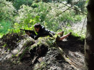 Child playing AR game outdoors in woodland at Inchmarlo, Aberdeenshire.