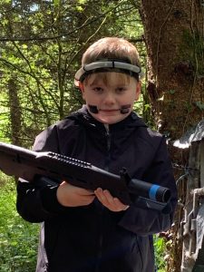 Young boy enjoying outdoor activities at Inchmarlo in wooded surroundings.