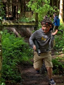 A person enjoying outdoor activities at Inchmarlo in a lush green forest setting.