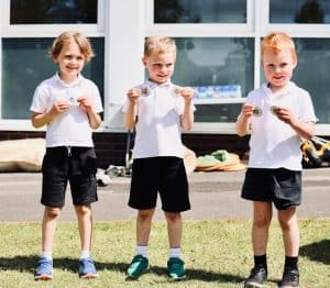 Three children outdoors enjoying ice cream at Inchmarlo.