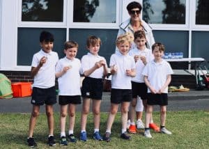 Group of children playing cricket outdoors at Inchmarlo School.