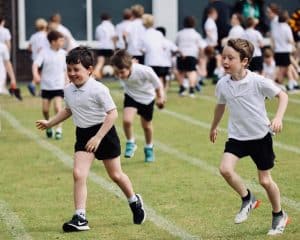 Children playing outdoors at Inchmarlo school sports event.