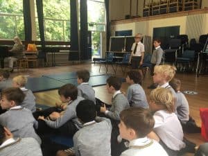 Students listening to a presentation in a classroom setting.