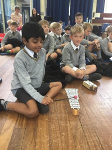 Children playing educational card game in classroom setting.