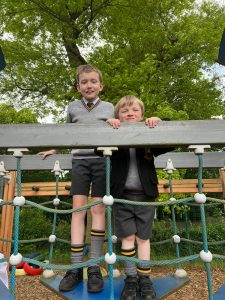 Two children playing on a climbing net at Inchmarlo outdoor playground.