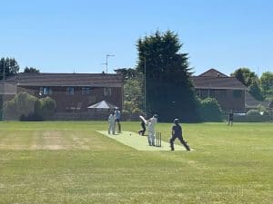 People playing golf on a lush green course at Inchmarlo, showing a scenic and well-maintained golf facility.