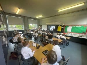 Students engaging with tablets and digital learning tools in a modern classroom at Inchmarlo.