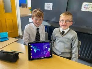 Two boys with a tablet in a classroom at Inchmarlo School.