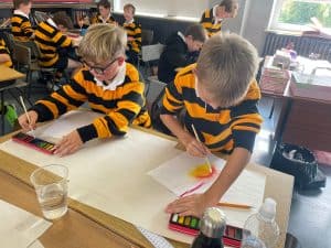 Young children engaging in classroom art activities at Inchmarlo School.