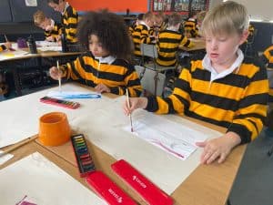 Students in matching uniforms engaged in classroom activities at Inchmarlo.