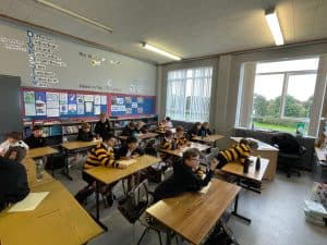 Students working in classroom with educational displays.