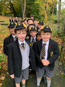 School children in uniform walking outdoors during fall at Inchmarlo.