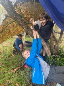 Children enjoying outdoor activities at Inchmarlo, surrounded by nature and trees.