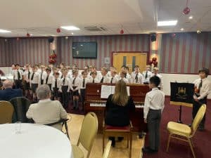 Students performing at Inchmarlo event, showcasing musical talent and community engagement.