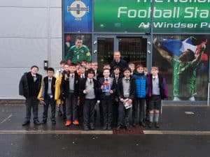 Group of children and adults outside Inchmarlo football stadium.