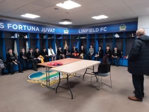 Modern locker room at Inchmarlo with football team and staff.