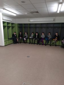People sitting in a modern indoor lounge at Inchmarlo Community Hub.