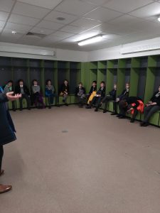 Participants gather in a circle during indoor activity at Inchmarlo.