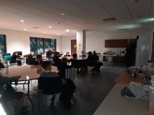 Indoor meeting room with people attending a presentation at Inchmarlo.