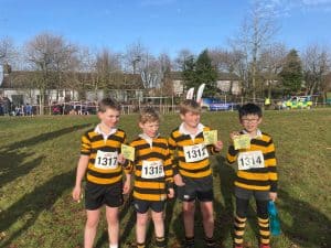 Group of young boys in sports uniforms at the Inchmarlo sports day, participating in a running event.