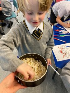 Young student with art supplies in classroom setting at Inchmarlo.