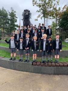Young students in school uniforms at Inchmarlo, surrounded by trees and outdoor scenery.