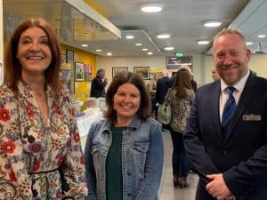 Warm, inviting indoor scene at Inchmarlo with smiling staff and guests.